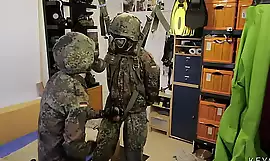 Two soldiers in German Flecktarn in gas masks wanking